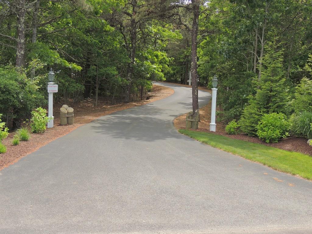 171 Great Neck Road Wareham, MA 02571 - Photo 2 of 26 a view of a street with a bench and trees