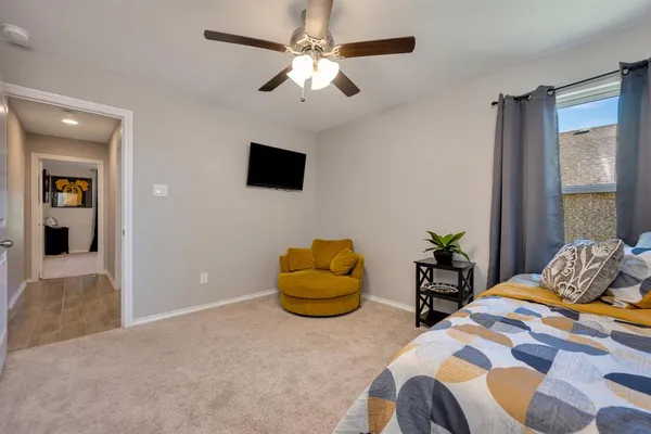 a bedroom with a bed and a couch