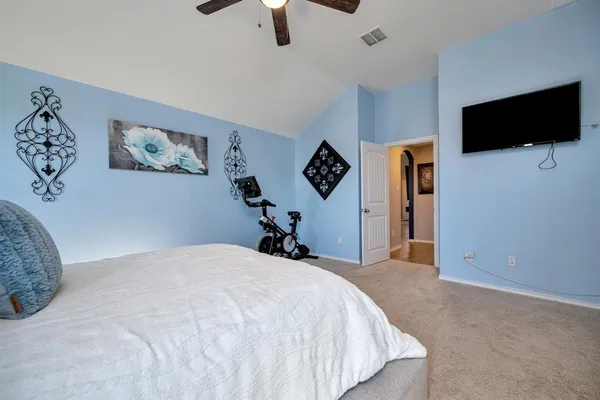 a bedroom with a bed and a chandelier