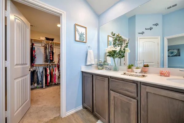 a bathroom with a shower sink and mirror