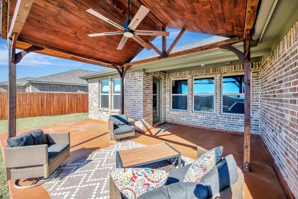 a view of backyard with wooden fence