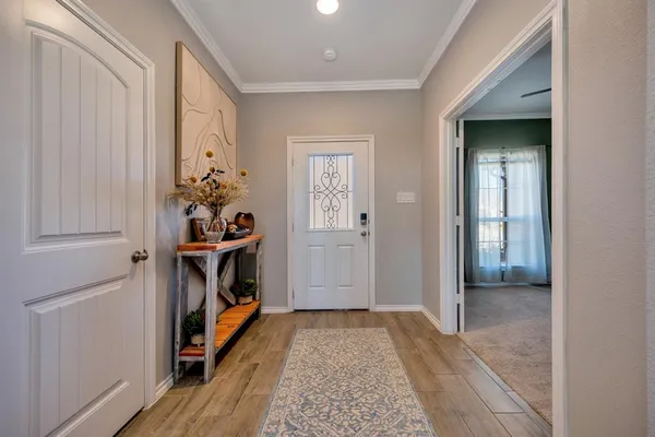 a view of an entryway with wooden floor