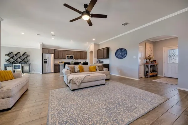 a living room with furniture and kitchen view