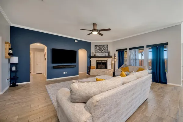 a living room with fireplace furniture and a flat screen tv