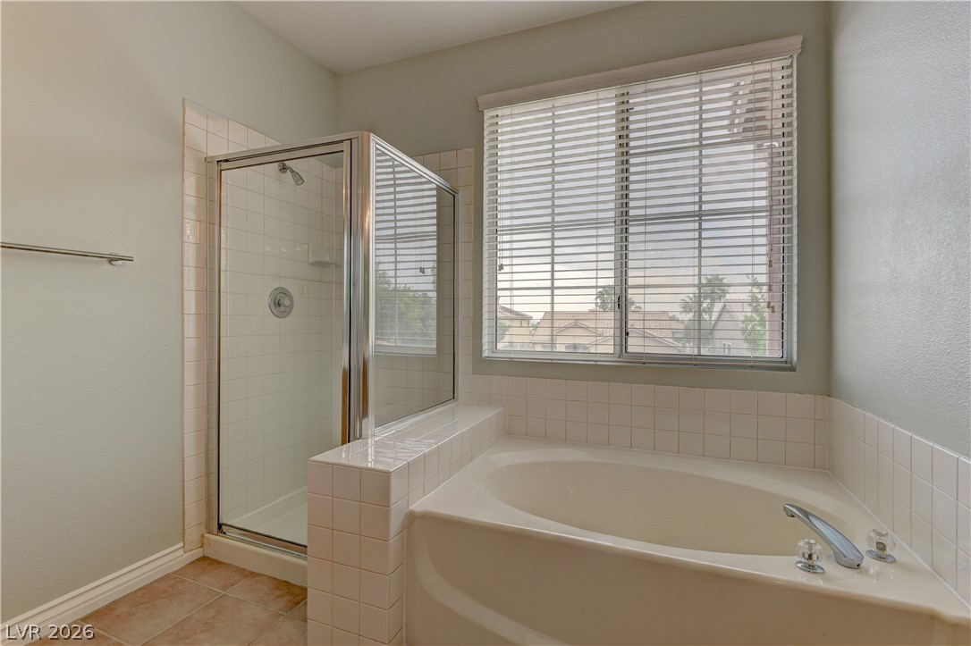 1813 Snow Spring Lane Las Vegas, NV 89134 - Photo 26 of 37 Relax in the deep soaking tub or refresh in the tiled walk-in shower.
