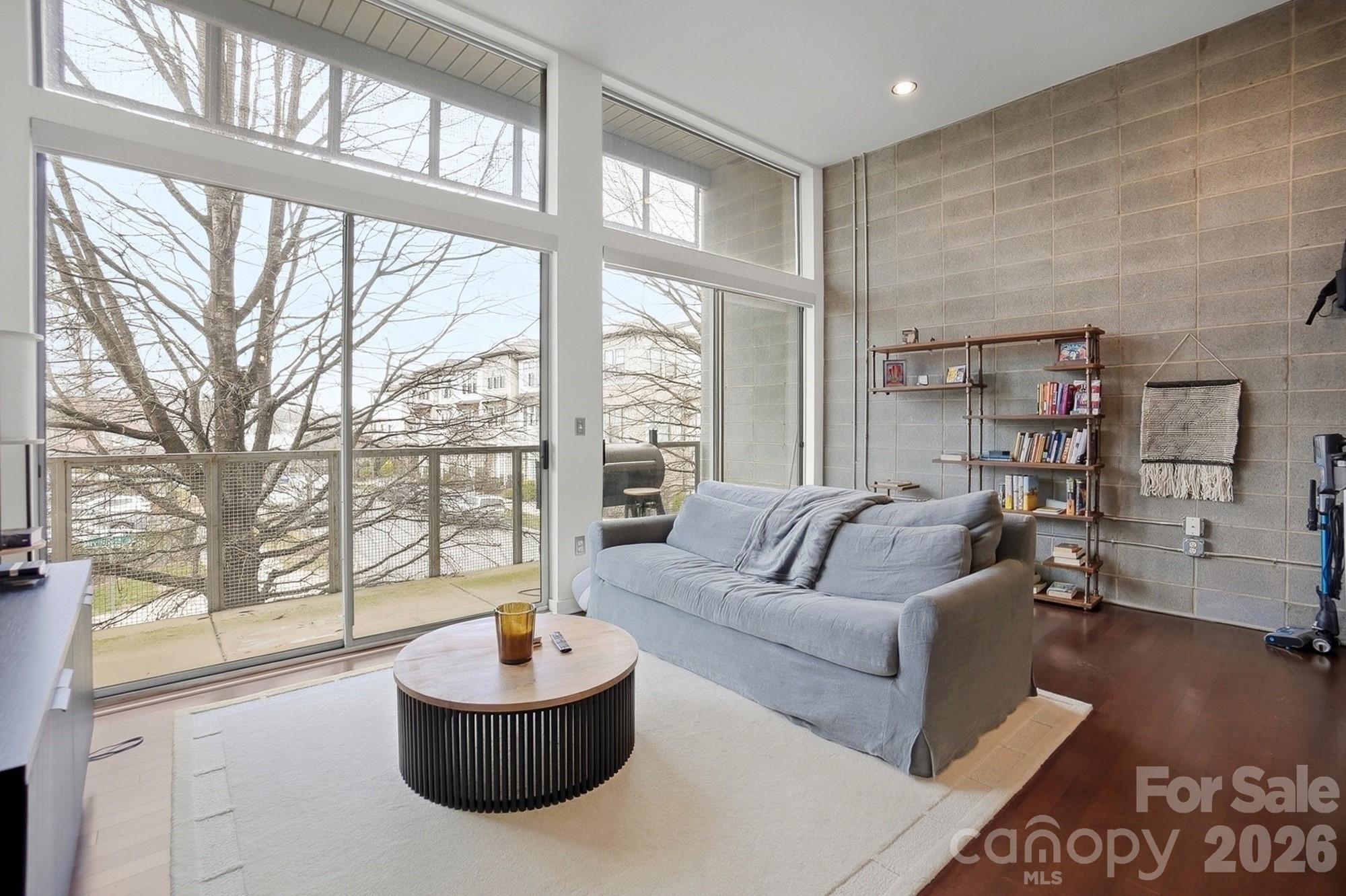 2116 McClintock Road, Unit 221 Charlotte, NC 28205 - Photo 11 of 44 a living room with furniture and a large window