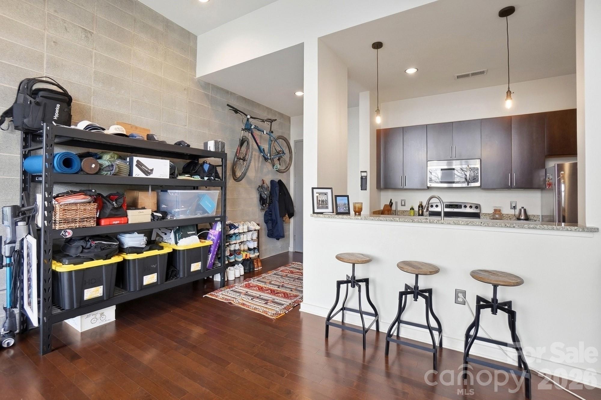 2116 McClintock Road, Unit 221 Charlotte, NC 28205 - Photo 13 of 44 a kitchen with stainless steel appliances granite countertop a kitchen island a stove and a refrigerator