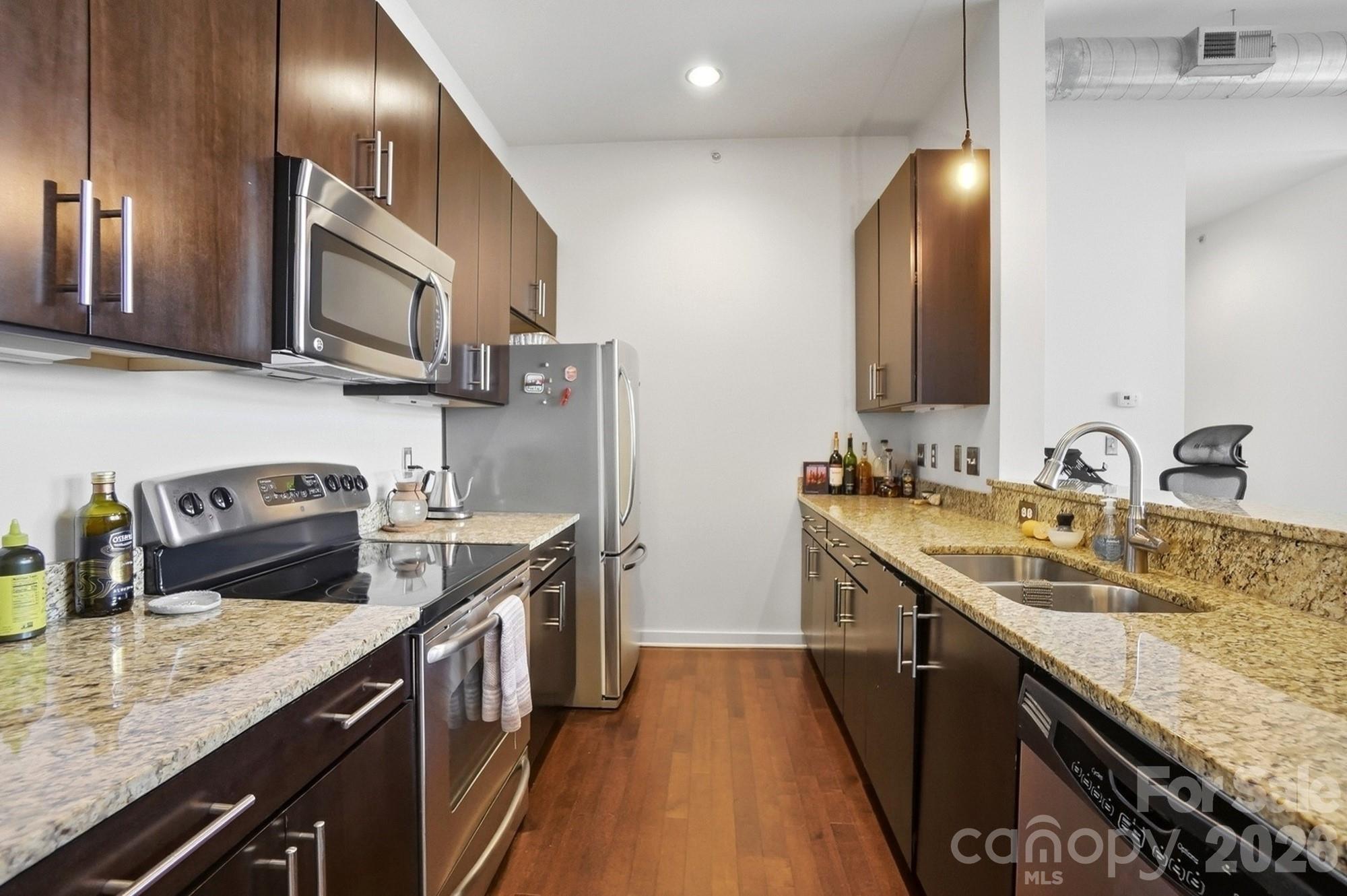 2116 McClintock Road, Unit 221 Charlotte, NC 28205 - Photo 15 of 44 a kitchen with stainless steel appliances granite countertop a sink a stove and a refrigerator