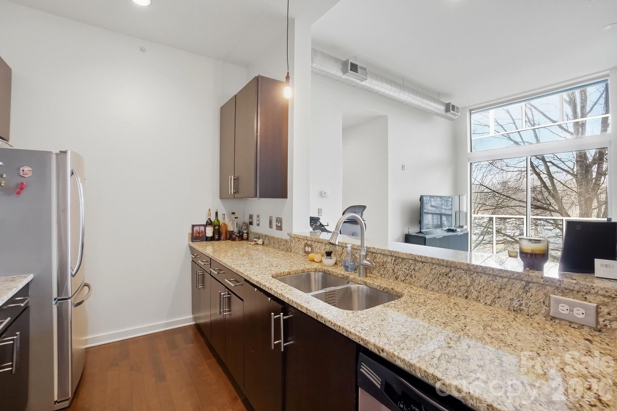 2116 McClintock Road, Unit 221 Charlotte, NC 28205 - Photo 16 of 44 a kitchen with a sink and a refrigerator