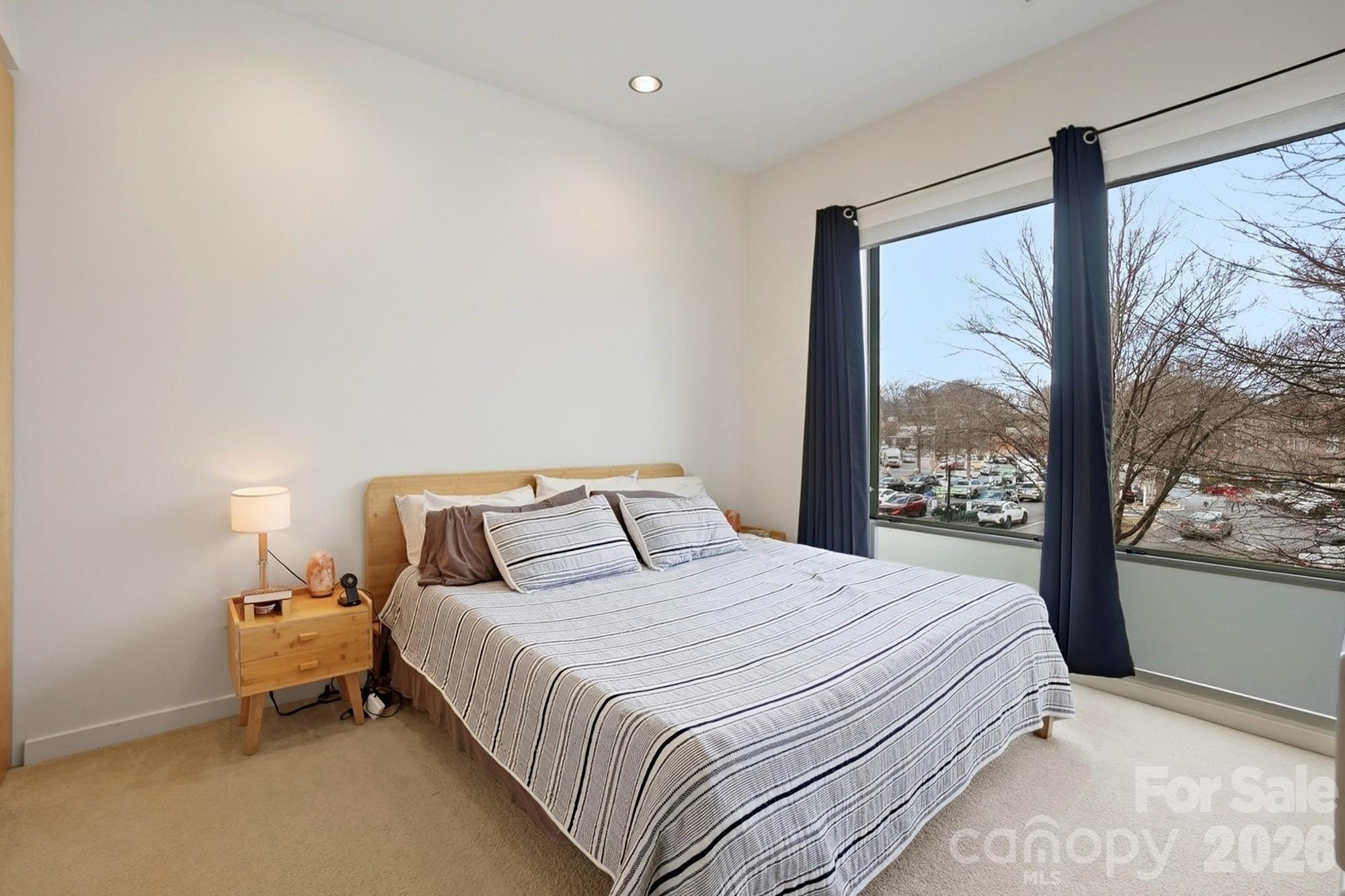 2116 McClintock Road, Unit 221 Charlotte, NC 28205 - Photo 20 of 44 a bedroom with a large bed and a large window