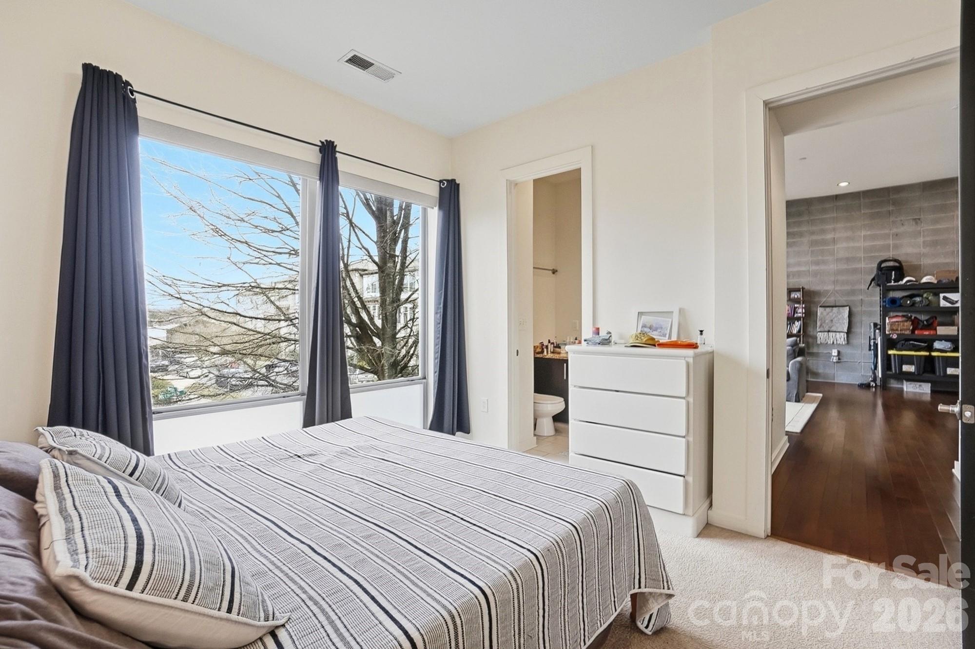 2116 McClintock Road, Unit 221 Charlotte, NC 28205 - Photo 21 of 44 a bedroom with a bed and a large window