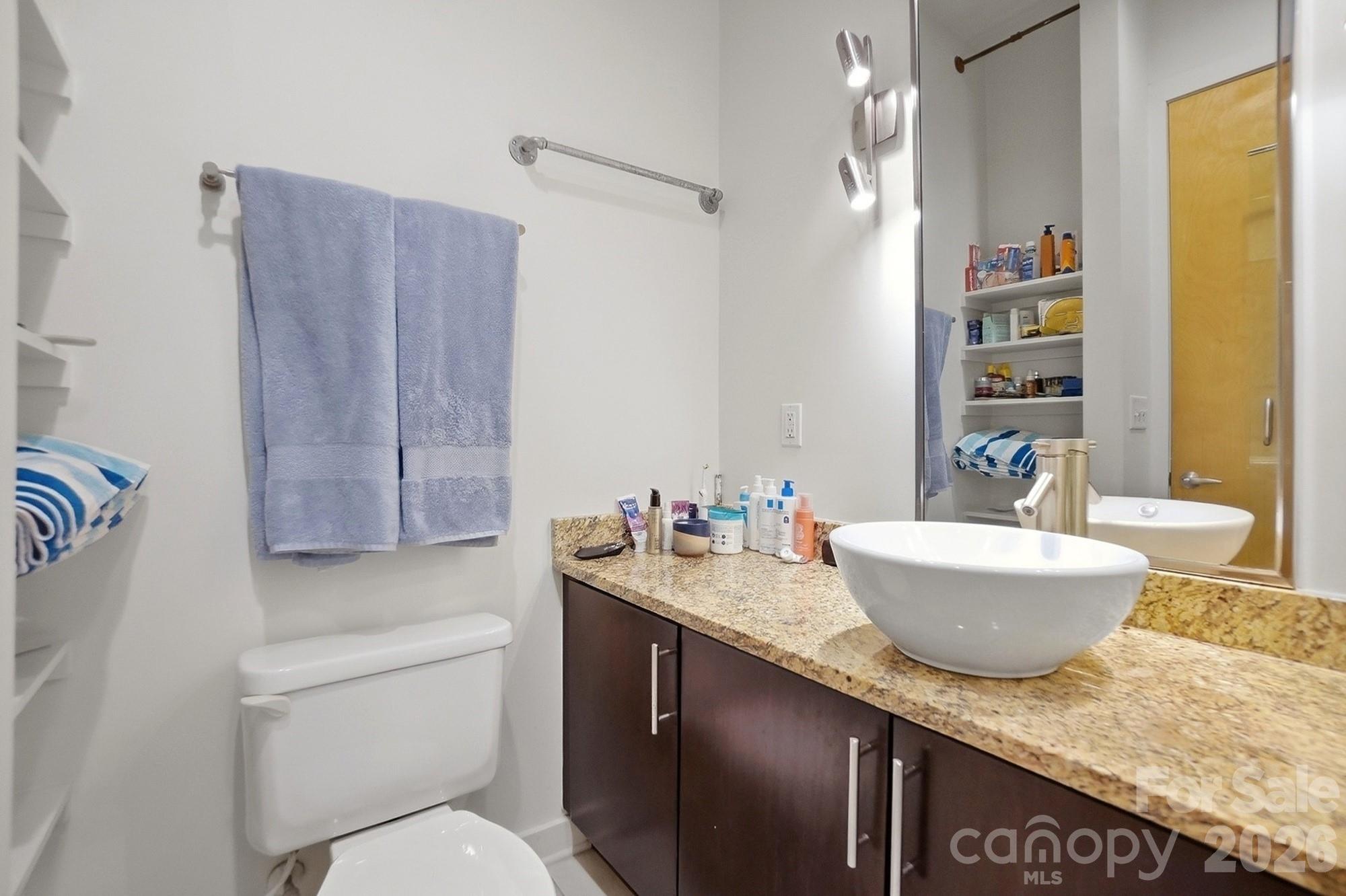 2116 McClintock Road, Unit 221 Charlotte, NC 28205 - Photo 25 of 44 a bathroom with a granite countertop sink a toilet and bathtub