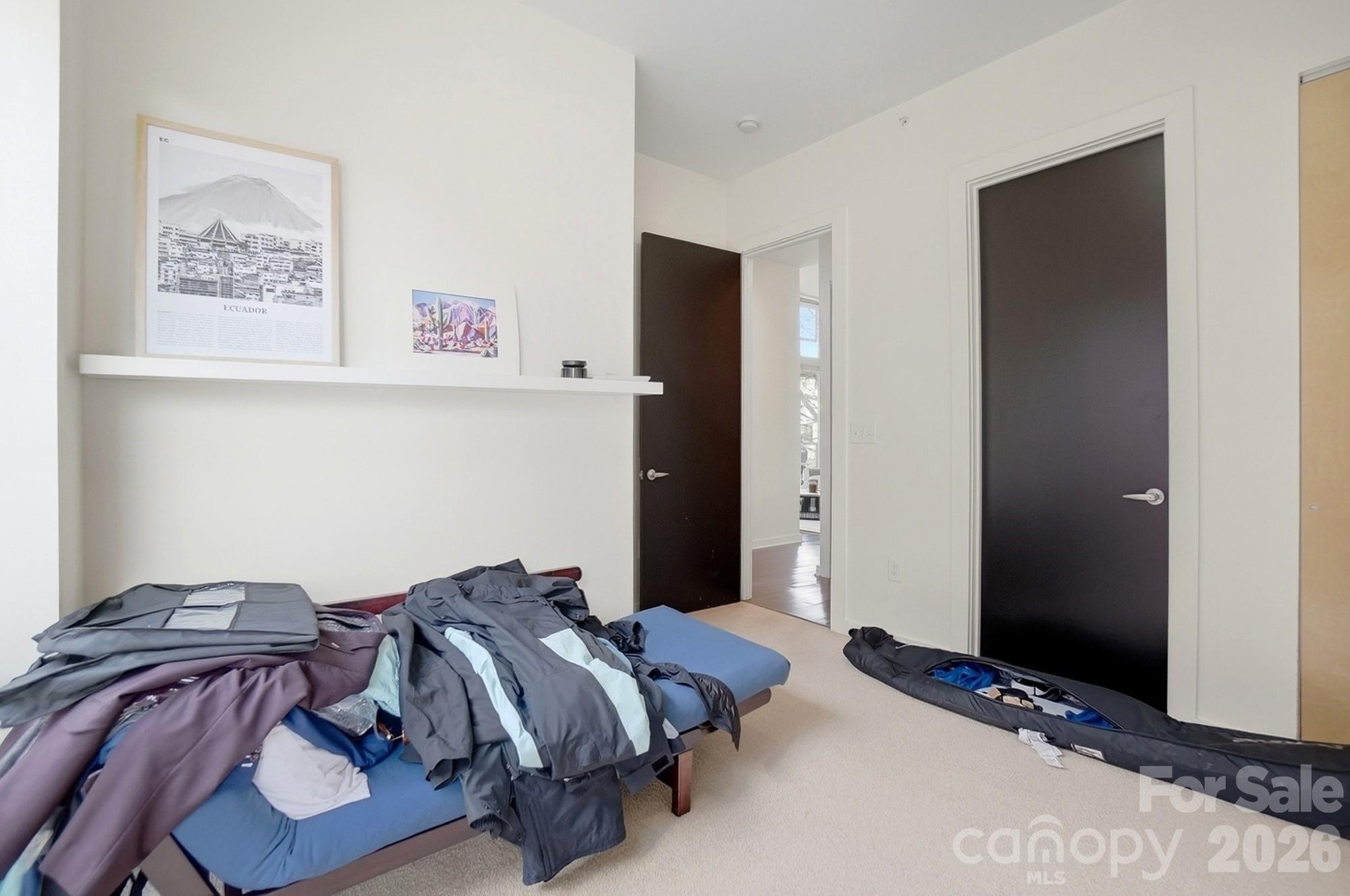 2116 McClintock Road, Unit 221 Charlotte, NC 28205 - Photo 28 of 44 a bed room with a bed and a night stand