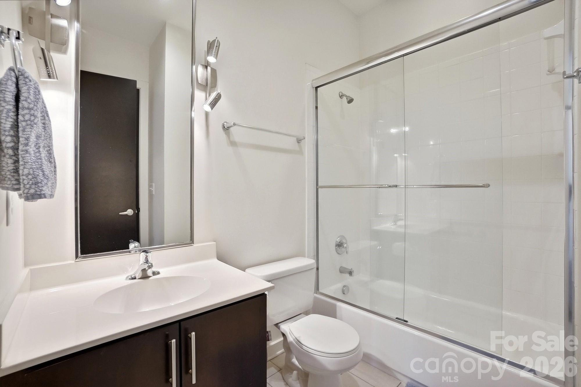 2116 McClintock Road, Unit 221 Charlotte, NC 28205 - Photo 30 of 44 a bathroom with a sink a toilet and shower