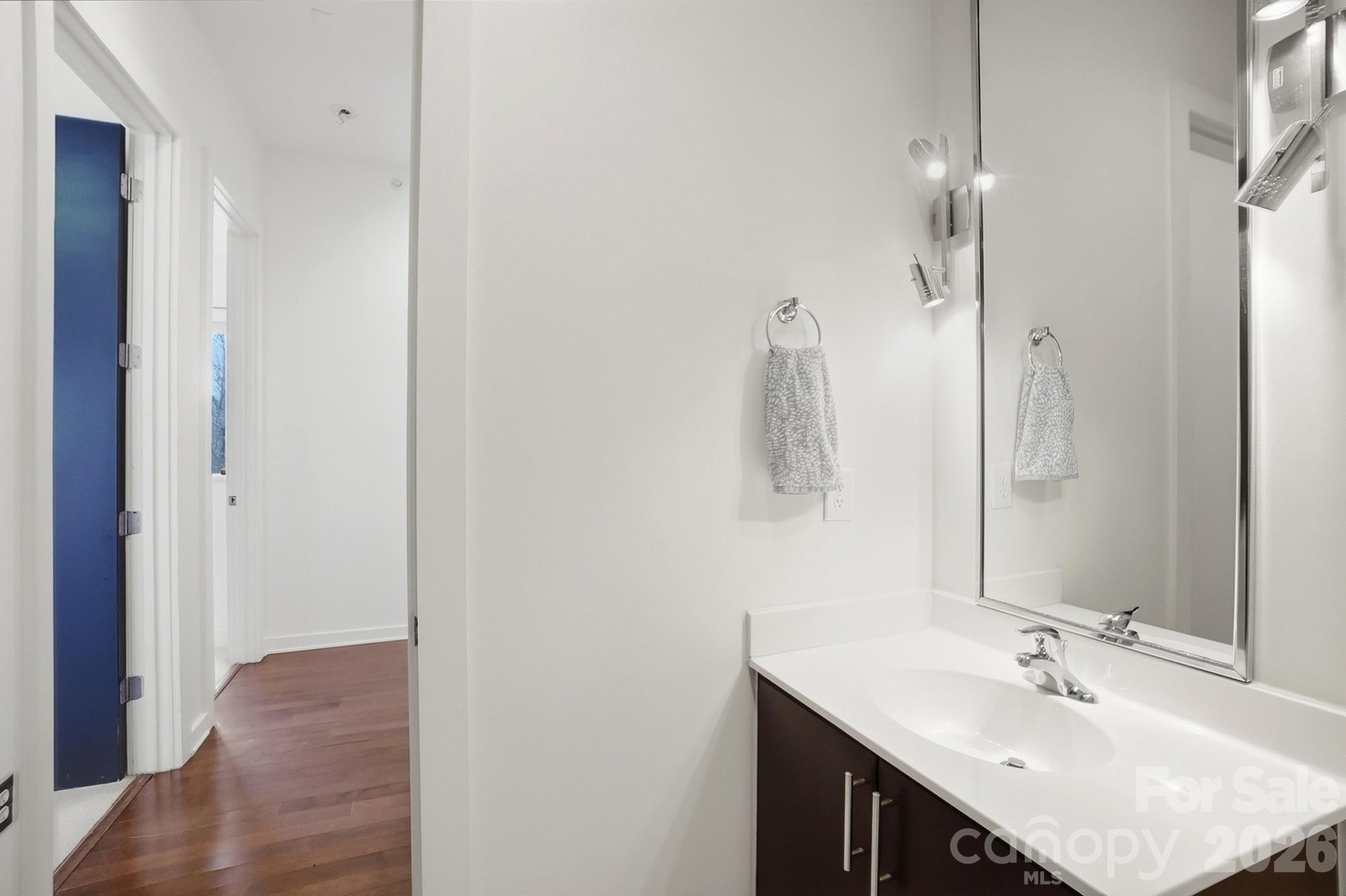 2116 McClintock Road, Unit 221 Charlotte, NC 28205 - Photo 31 of 44 a bathroom with a sink vanity granite and a mirror