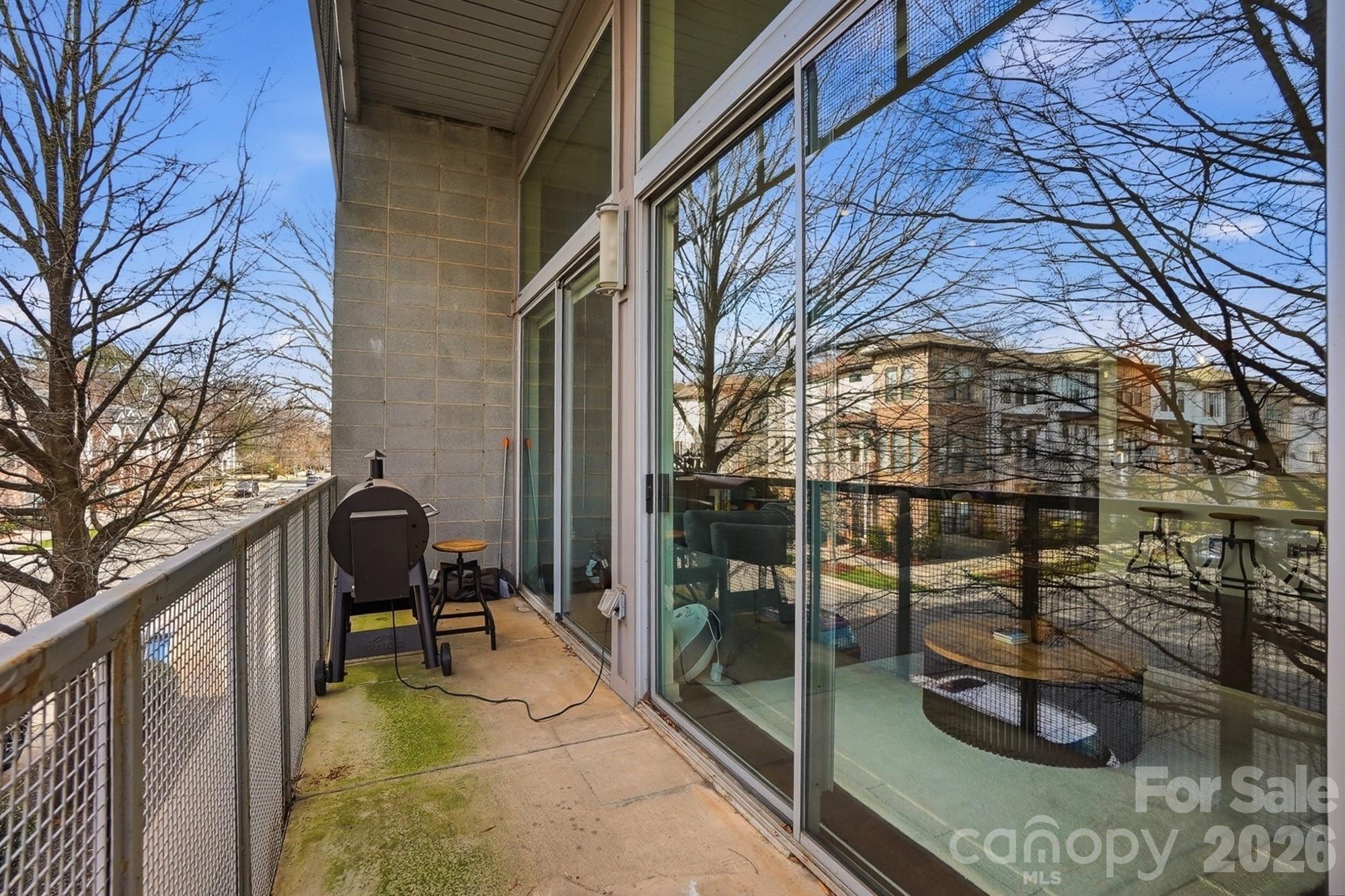 2116 McClintock Road, Unit 221 Charlotte, NC 28205 - Photo 33 of 44 a view of balcony with couch and potted plants