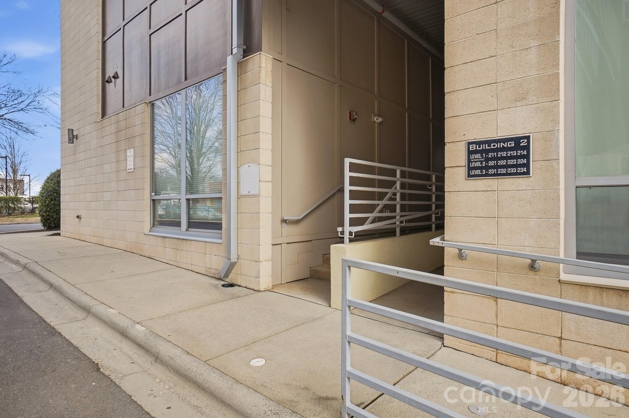 2116 McClintock Road, Unit 221 Charlotte, NC 28205 - Photo 37 of 44 a view of the wooden door and two windows