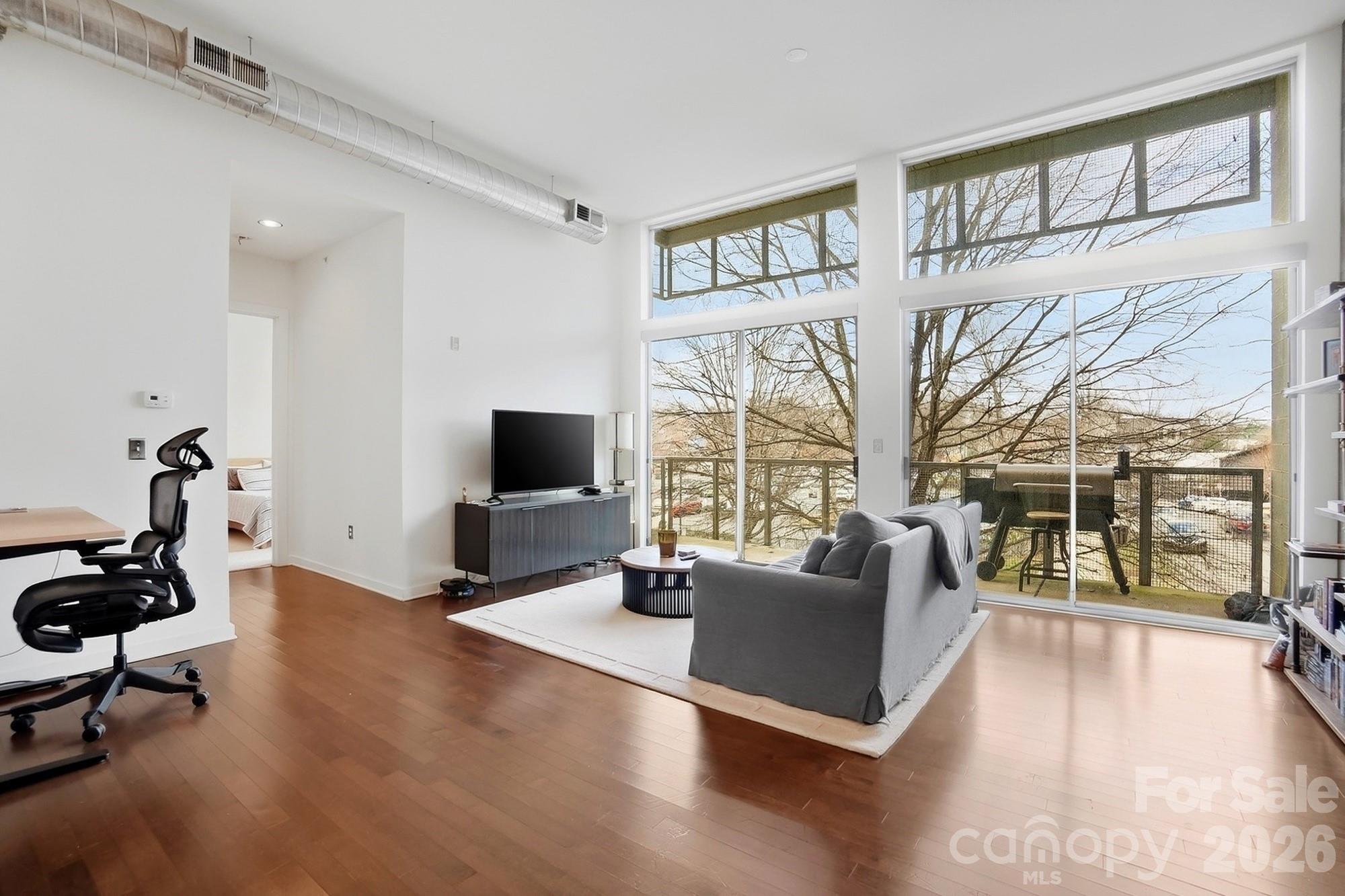 2116 McClintock Road, Unit 221 Charlotte, NC 28205 - Photo 7 of 44 a living room with furniture large window and a flat screen tv