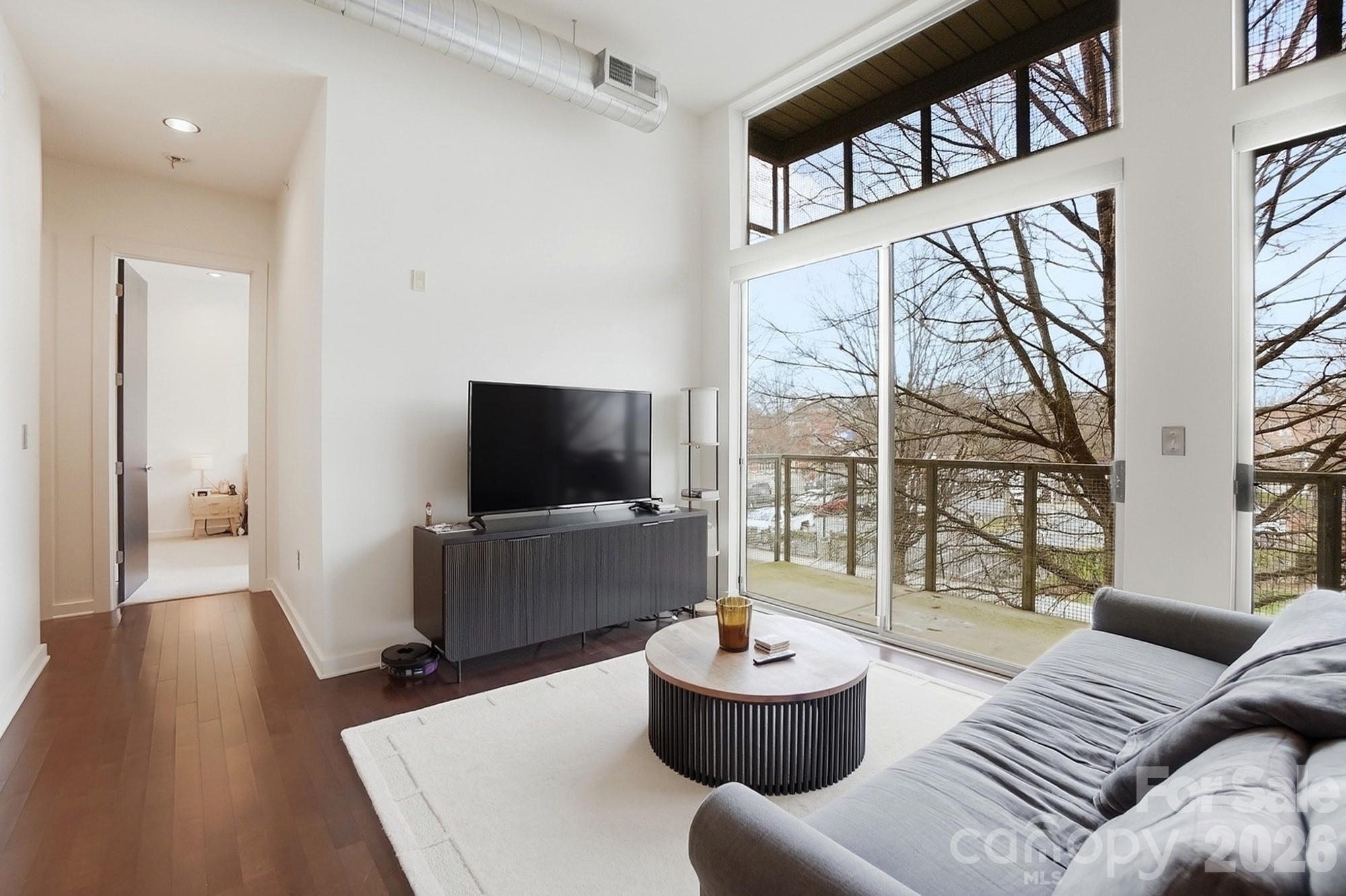 2116 McClintock Road, Unit 221 Charlotte, NC 28205 - Photo 8 of 44 a living room with furniture and a large window