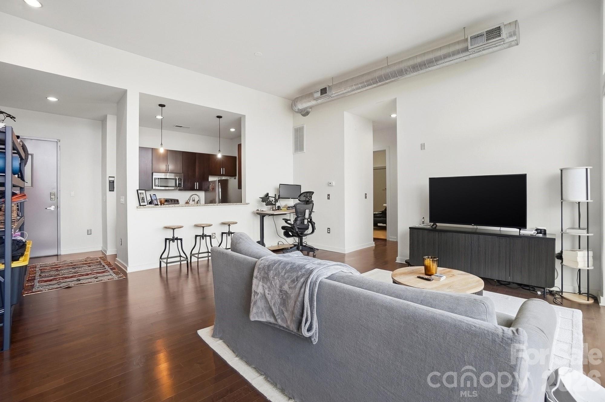 2116 McClintock Road, Unit 221 Charlotte, NC 28205 - Photo 9 of 44 a living room with furniture and a flat screen tv