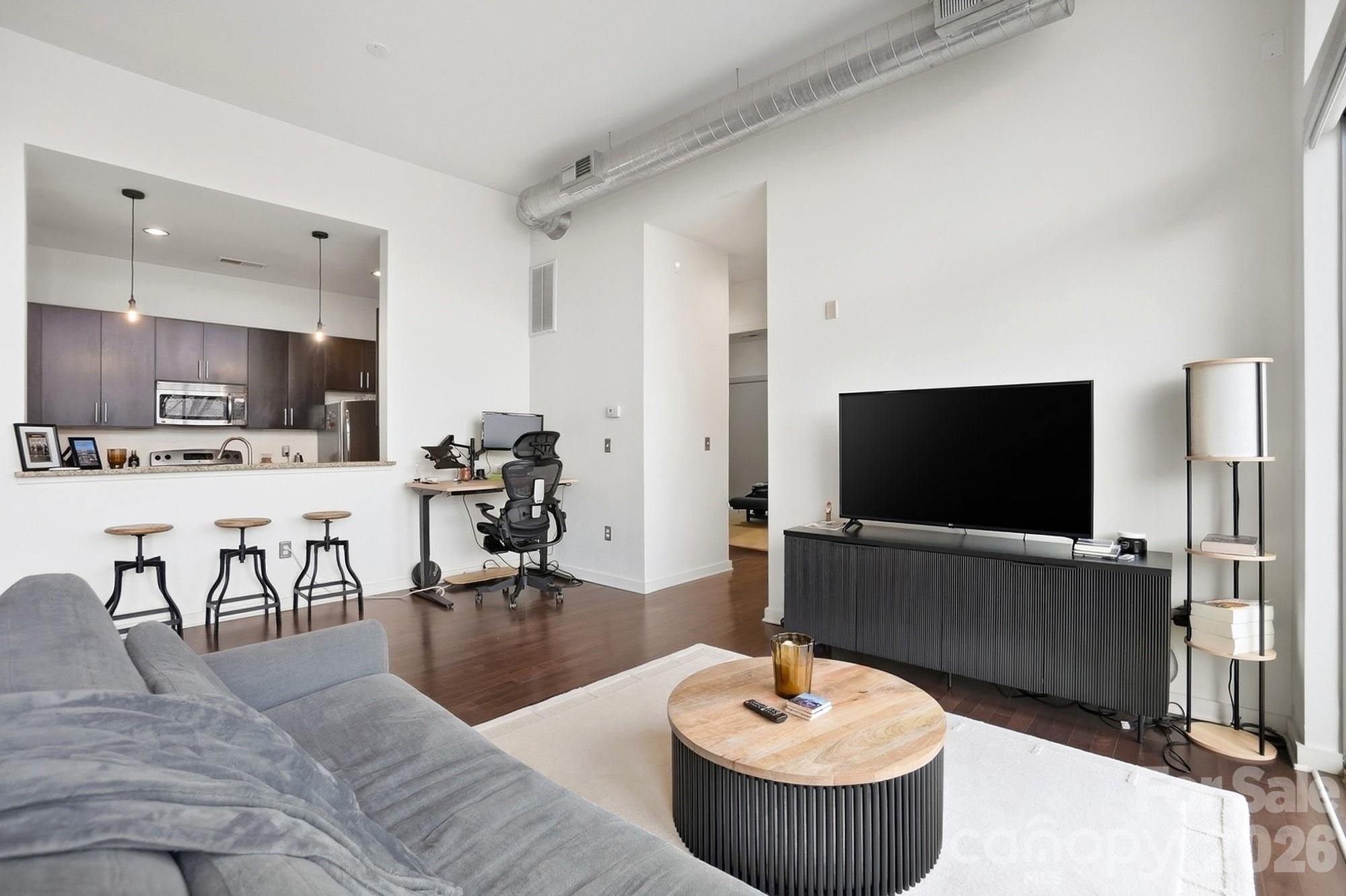 2116 McClintock Road, Unit 221 Charlotte, NC 28205 - Photo 10 of 44 a living room with furniture and a flat screen tv