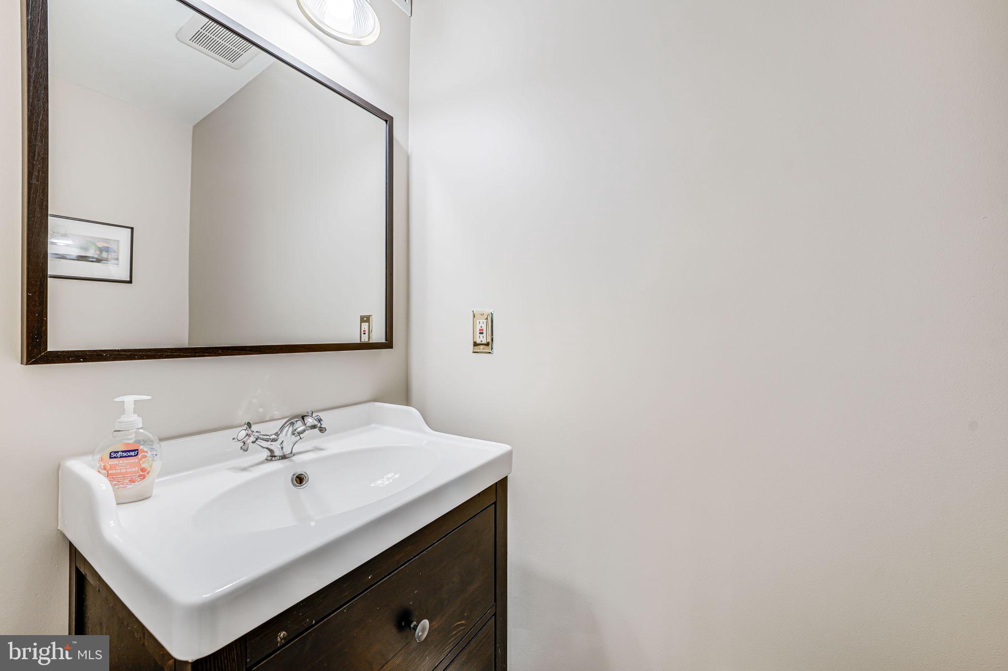 9802 Natick Road Burke, VA 22015 - Photo 15 of 45 a bathroom with a sink and a mirror