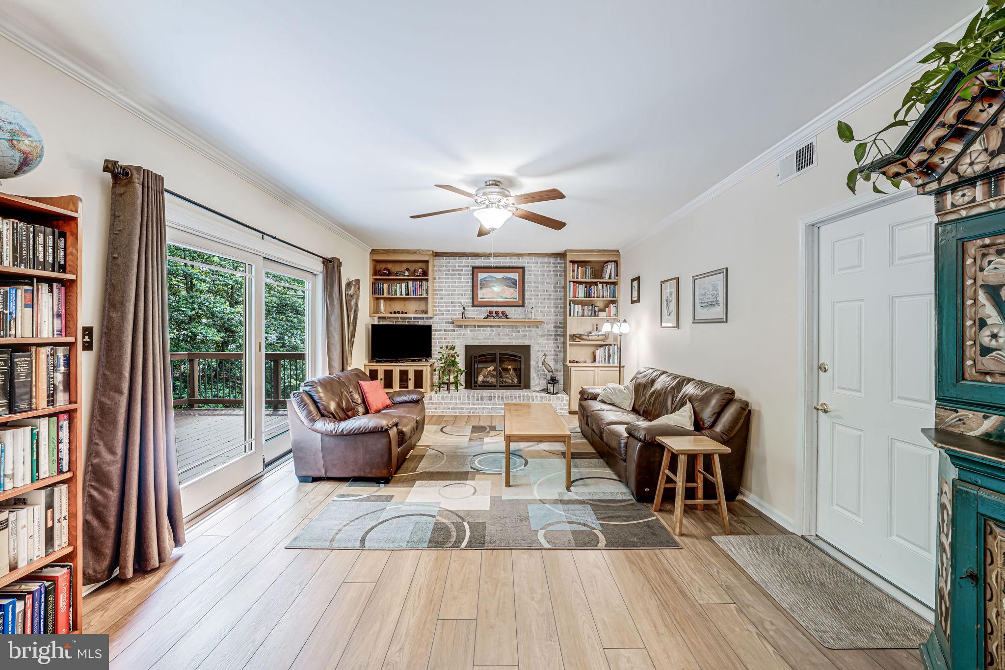9802 Natick Road Burke, VA 22015 - Photo 16 of 45 a living room with fireplace furniture and a wooden floor