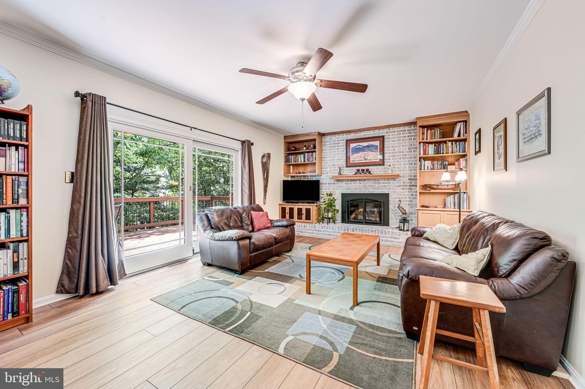 9802 Natick Road Burke, VA 22015 - Photo 17 of 45 a living room with fireplace furniture and a large window