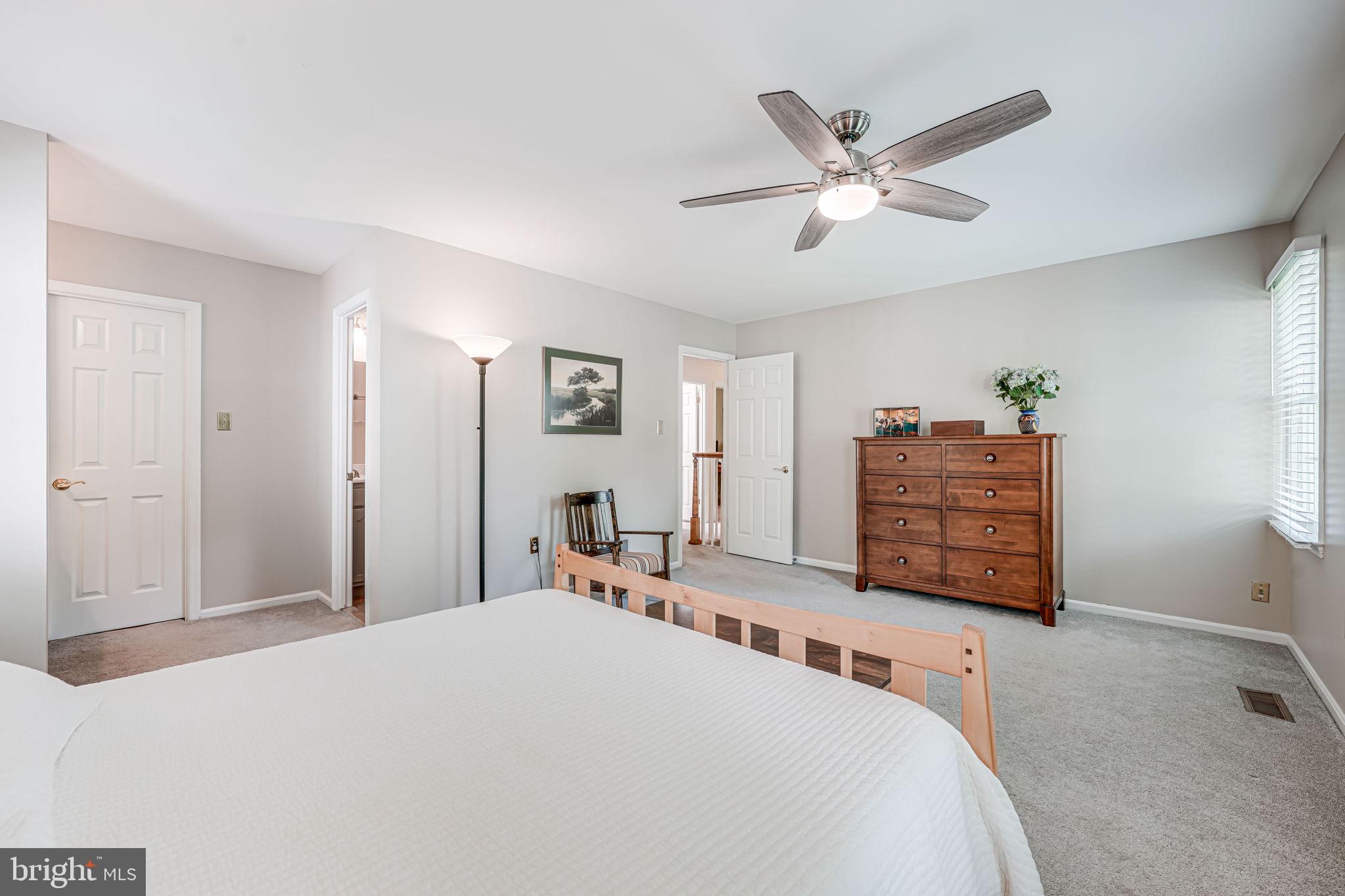9802 Natick Road Burke, VA 22015 - Photo 28 of 45 a bedroom with a bed and a ceiling fan