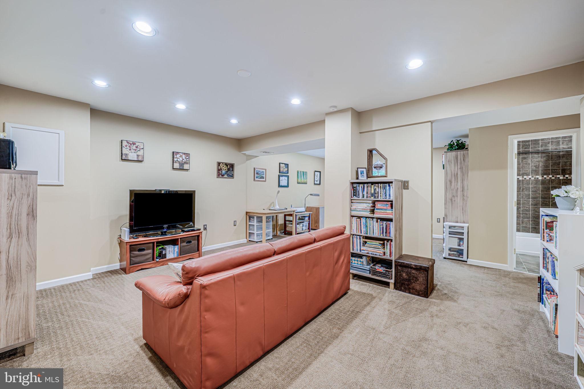 9802 Natick Road Burke, VA 22015 - Photo 31 of 45 a living room with furniture and a flat screen tv