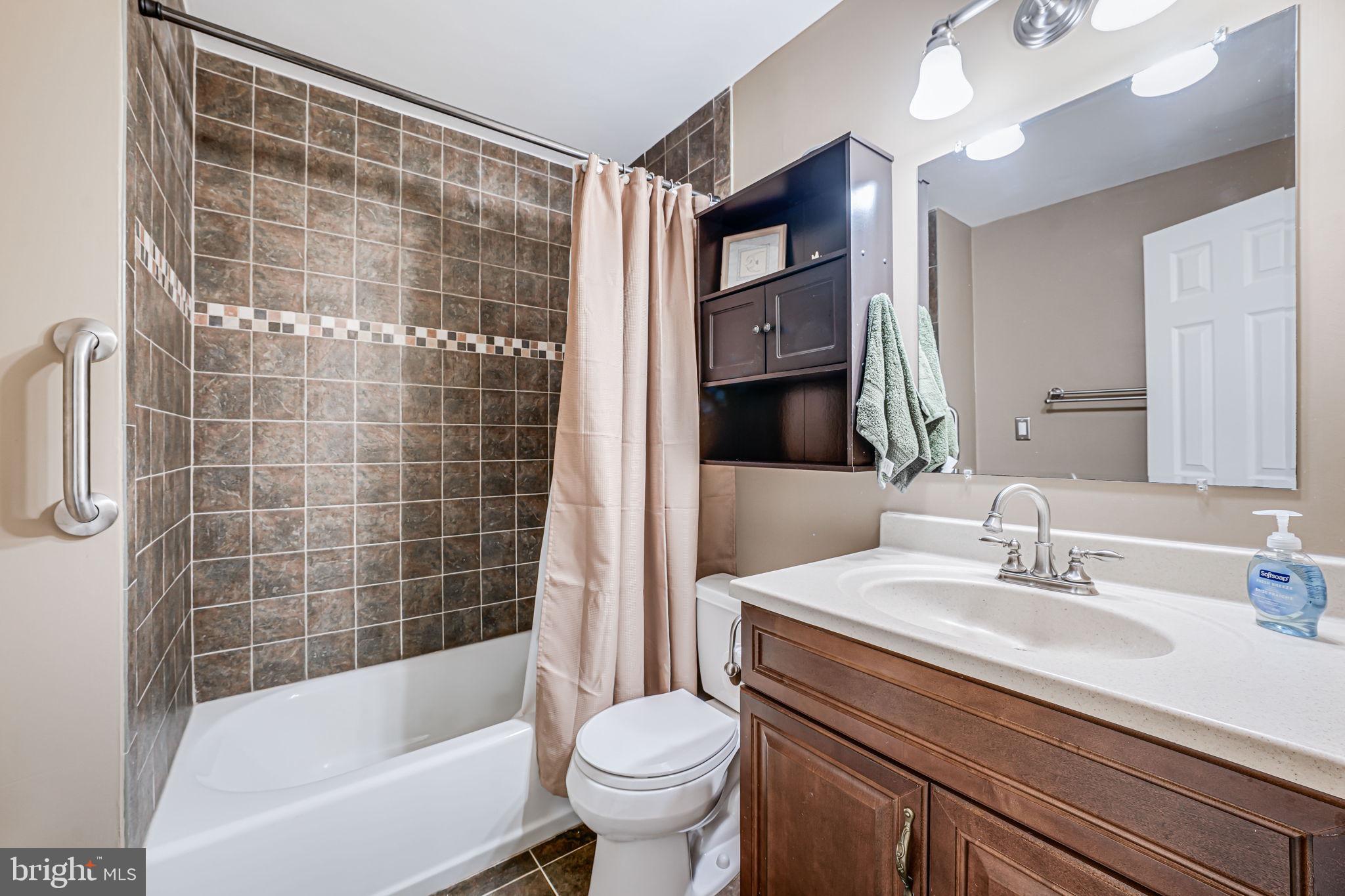 9802 Natick Road Burke, VA 22015 - Photo 34 of 45 a bathroom with a sink toilet and shower