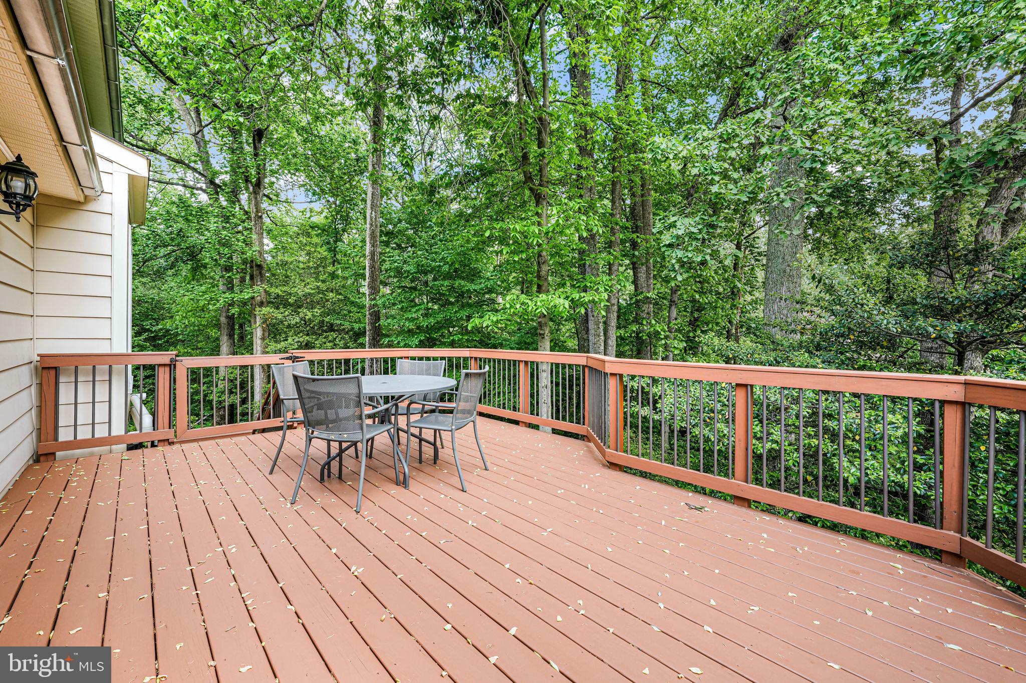 9802 Natick Road Burke, VA 22015 - Photo 37 of 45 a view of a deck with table and chairs and wooden floor
