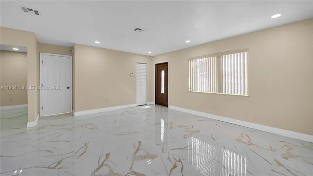 a view of an empty room with a window