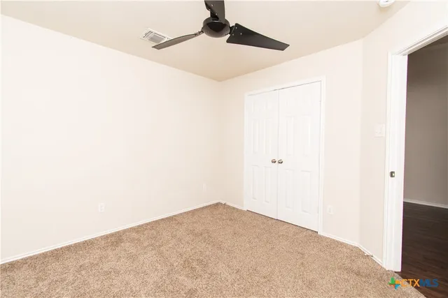 a view of a big room with closet and wooden floor