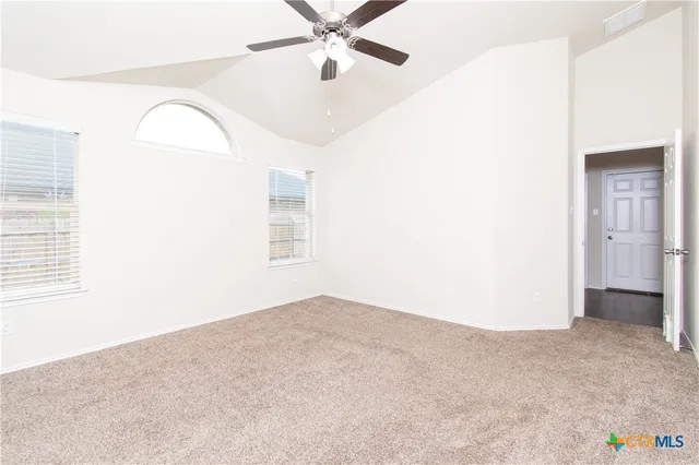 a view of an empty room with a window