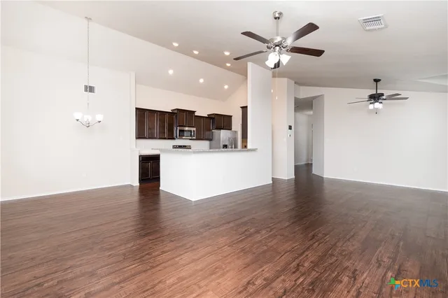 a view of a kitchen with a sink and a ceiling fan