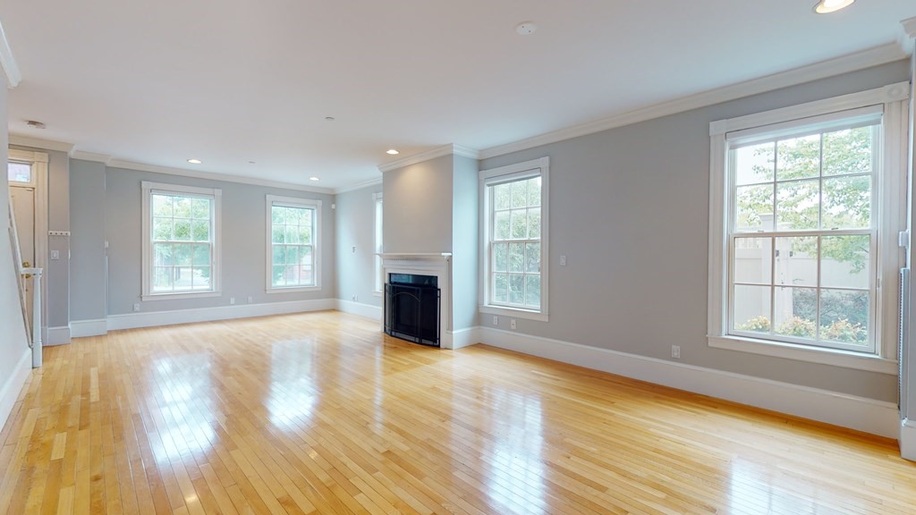 90 Constitution Road, Unit 90 Boston, MA 02129 - Photo 13 of 37 a view of an empty room with a window and wooden floor