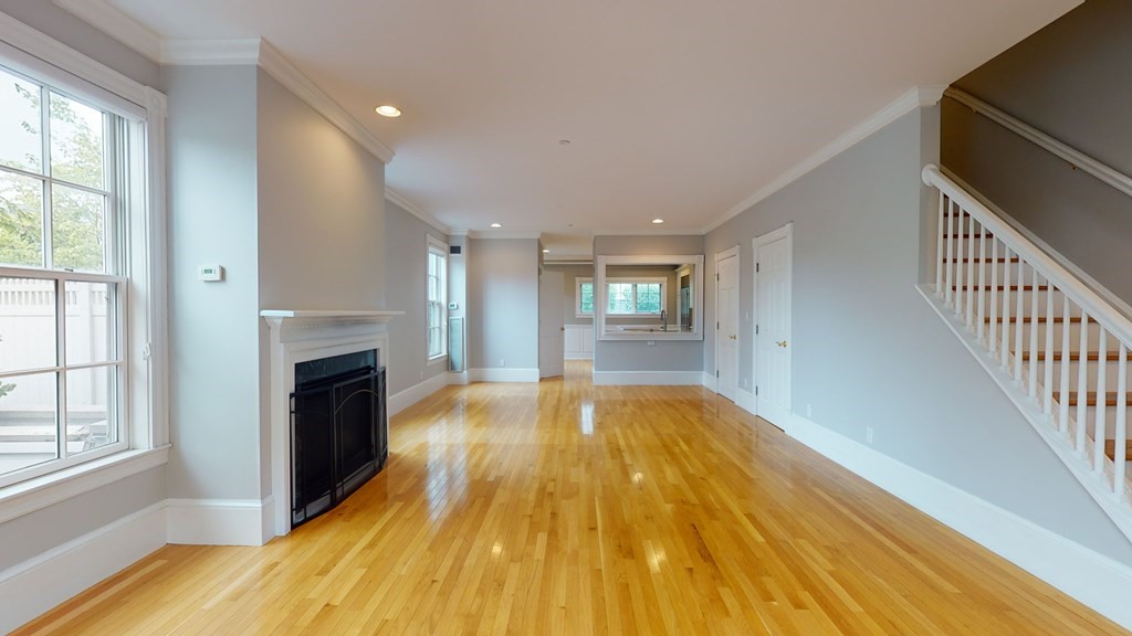 90 Constitution Road, Unit 90 Boston, MA 02129 - Photo 16 of 37 a view of empty room with wooden floor and fireplace
