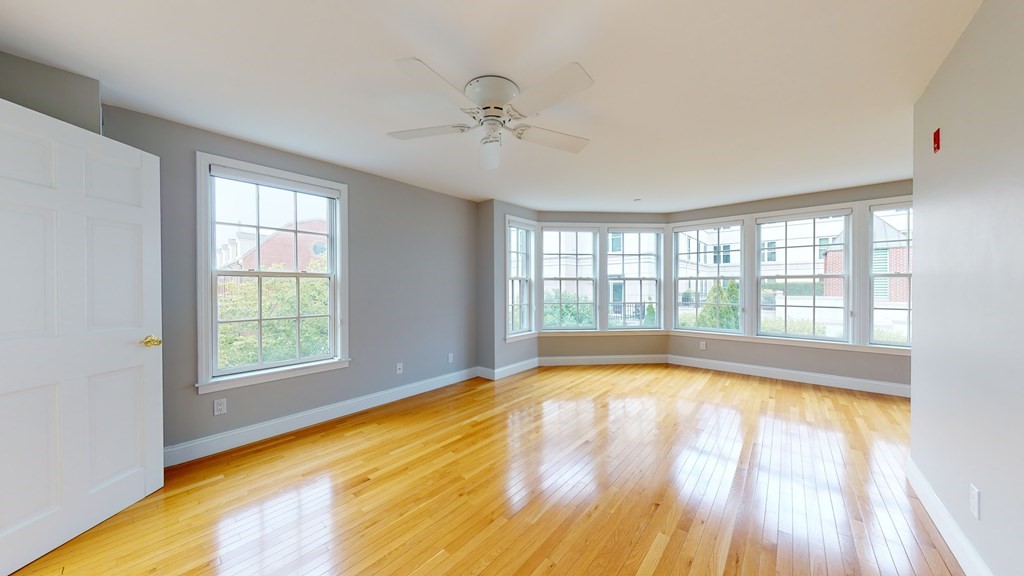 90 Constitution Road, Unit 90 Boston, MA 02129 - Photo 23 of 37 a view of an empty room with a window and wooden floor