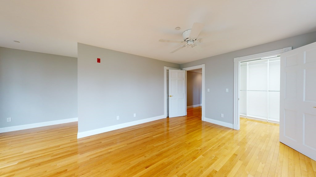 90 Constitution Road, Unit 90 Boston, MA 02129 - Photo 24 of 37 a view of an empty room with wooden floor