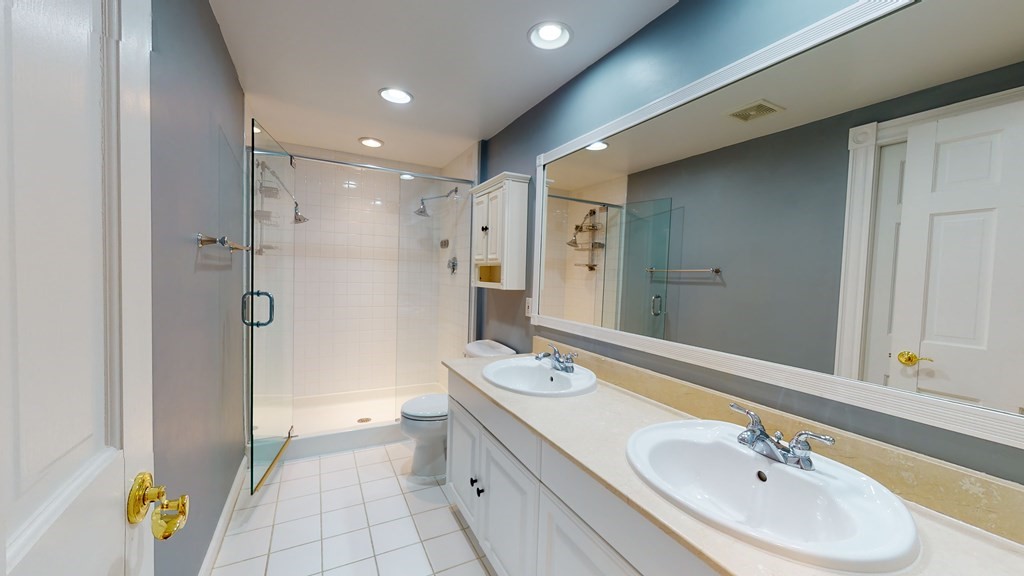 90 Constitution Road, Unit 90 Boston, MA 02129 - Photo 26 of 37 a bathroom with a double vanity sink and a mirror