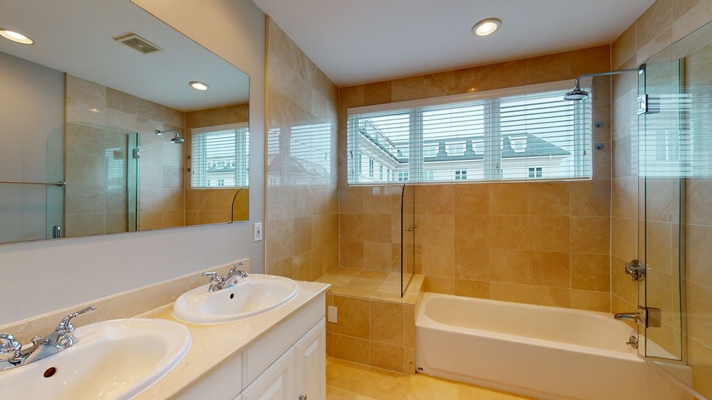 90 Constitution Road, Unit 90 Boston, MA 02129 - Photo 30 of 37 a bathroom with a tub sink shower and a mirror