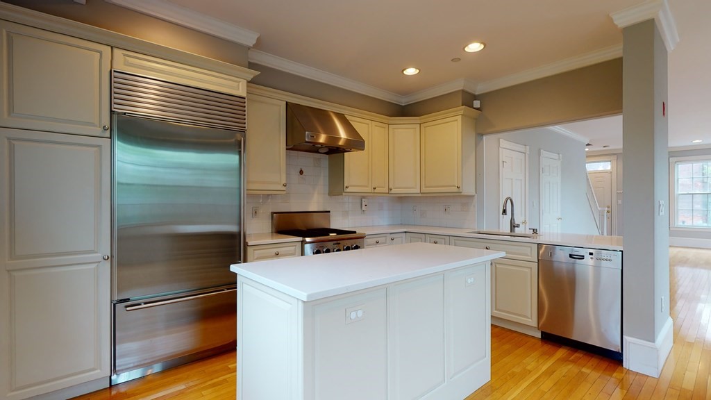 90 Constitution Road, Unit 90 Boston, MA 02129 - Photo 3 of 37 a kitchen with a refrigerator sink and cabinets