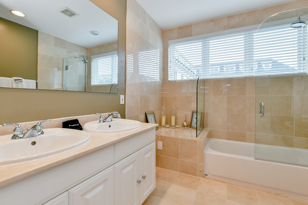 90 Constitution Road, Unit 90 Boston, MA 02129 - Photo 31 of 37 a bathroom with a tub sink and mirror
