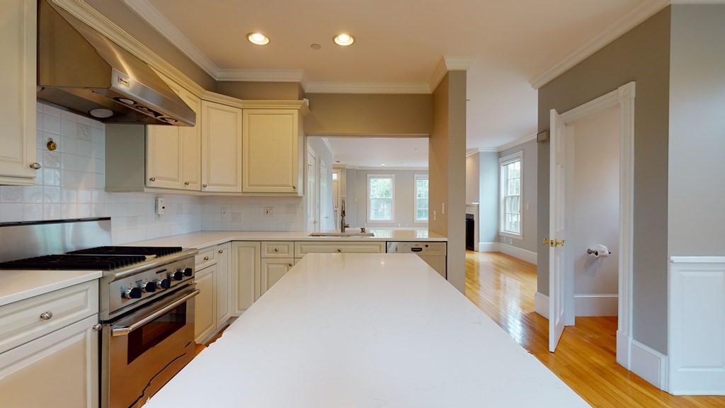 90 Constitution Road, Unit 90 Boston, MA 02129 - Photo 5 of 37 a kitchen with stainless steel appliances a stove a sink and a refrigerator