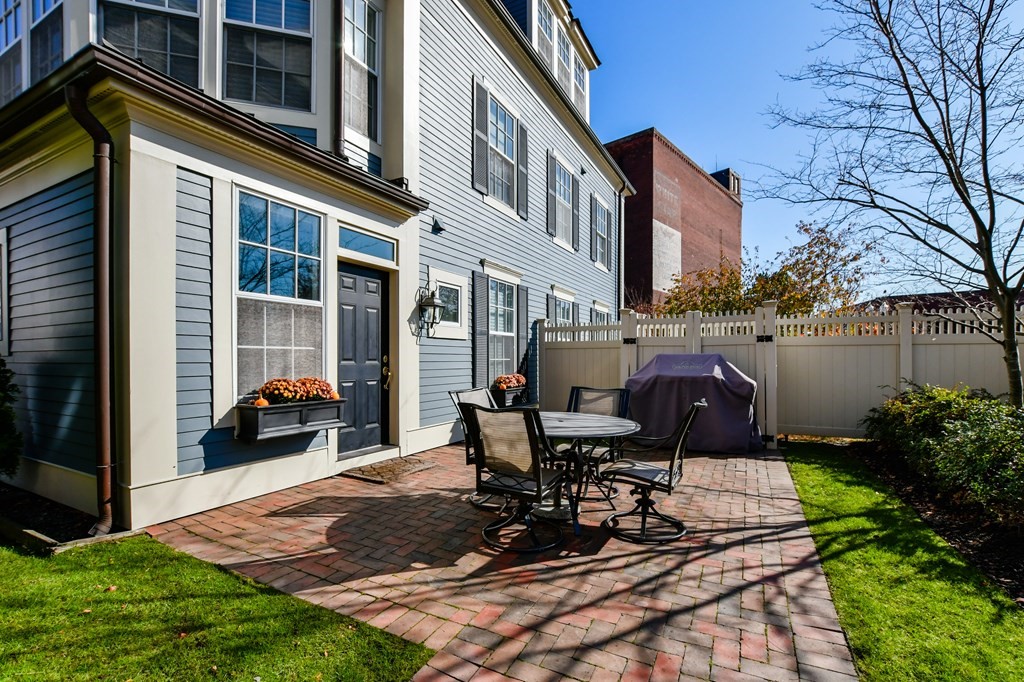 90 Constitution Road, Unit 90 Boston, MA 02129 - Photo 6 of 37 a view of a patio with table and chairs and potted plants