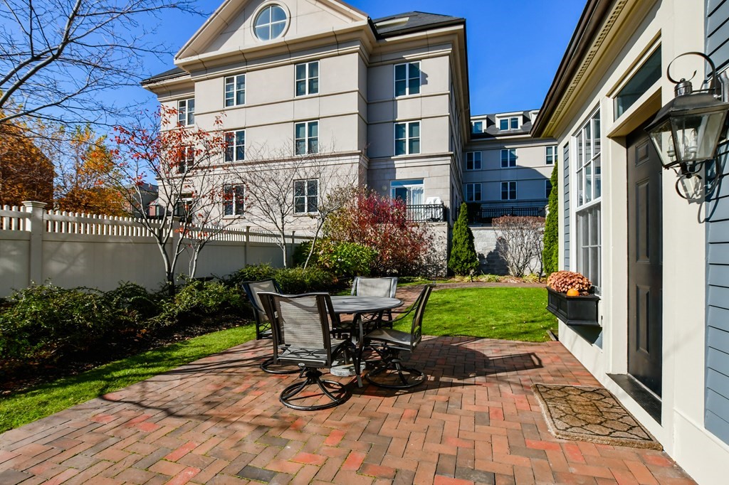 90 Constitution Road, Unit 90 Boston, MA 02129 - Photo 7 of 37 a view of a chairs and table in patio with a barbeque