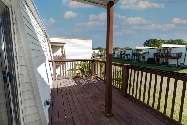 a view of a balcony with wooden floor