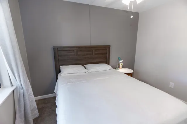 a bedroom with a bed and a window