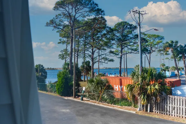 a backyard of a house with lots of green space and outdoor seating